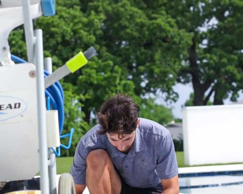 Man checking the chemical levels in a pool