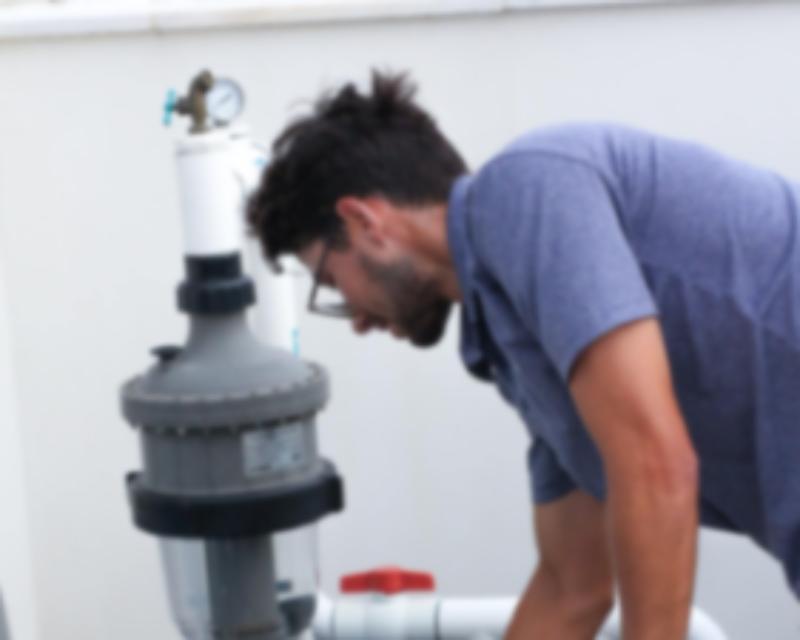Man checking a pool pump